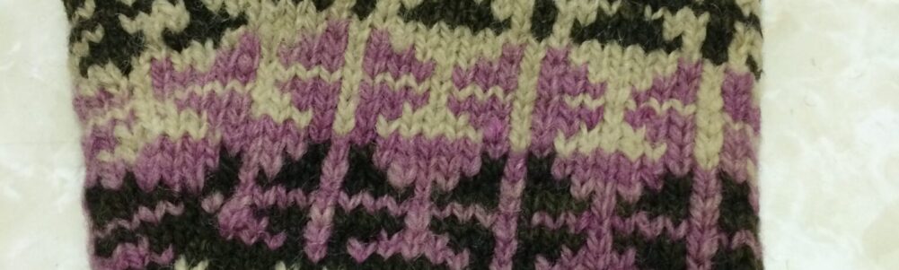 One of the pair of knitted gloves owned by Herbert Wheeler. Donated by Pearl Wheeler in 1972.