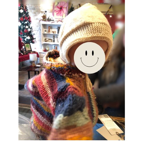 Knitted wool bonnet on toddler model