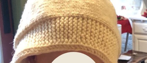 Knitted 'Beloved' baby bonnet on toddler model Knitted baby bonnet and model